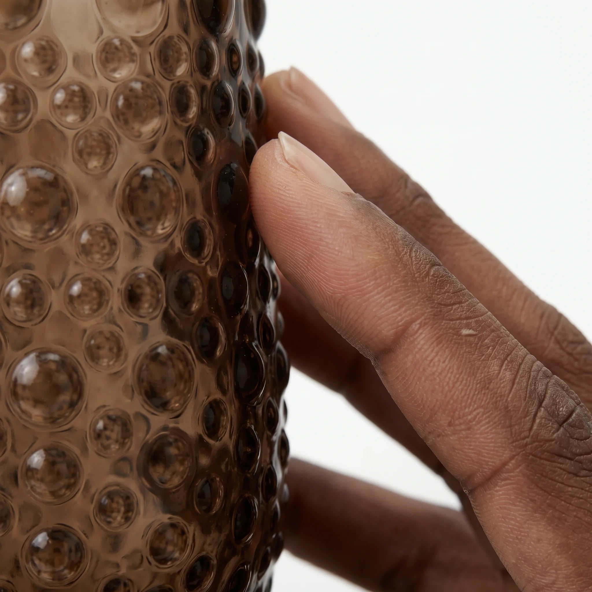 Fingertip against the hobnail relief